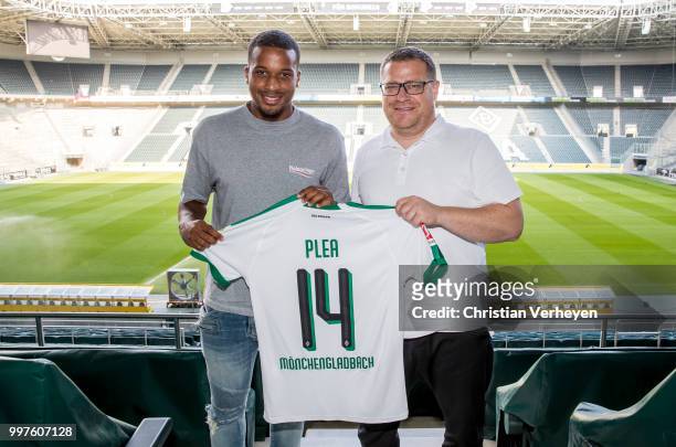 Director of Sport Max Eberl pose with Alassane Plea after he signs a new contract for Borussia Moenchengladbach at Borussia-Park on July 12, 2018 in...