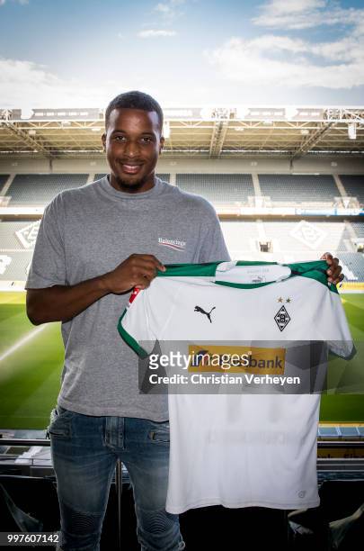 Alassane Plea pose with his new shirt after he signs a new contract for Borussia Moenchengladbach at Borussia-Park on July 12, 2018 in...