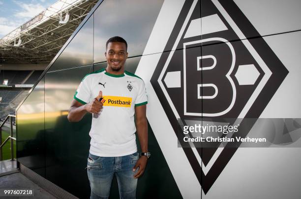 Alassane Plea pose with his new shirt after he signs a new contract for Borussia Moenchengladbach at Borussia-Park on July 12, 2018 in...
