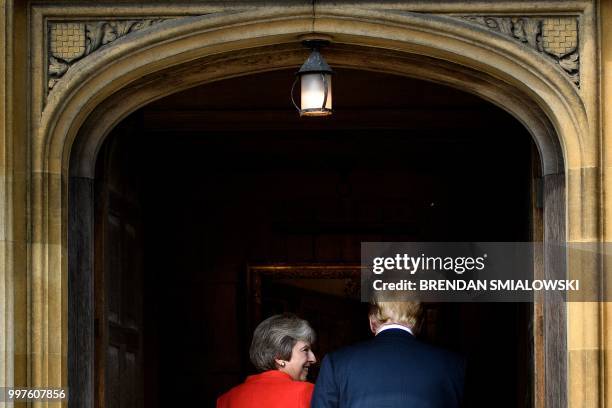 Britain's Prime Minister Theresa May and US President Donald Trump walk on his arrival for a meeting at Chequers, the prime minister's country...