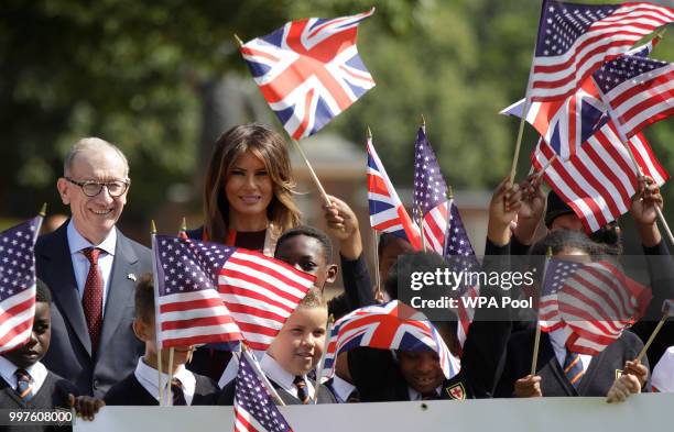 First Lady Melania Trump and Philip May, the husband of British Prime Minister Theresa May stand with school children during a visit to British...