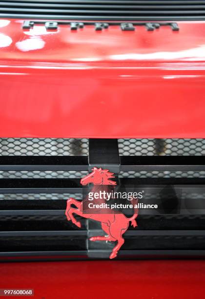 The Ferrari emblem, a jumping horse, seen on a Ferrari Testarossa from 1988 in the Auto & Technik Museum in Sinsheim, Germany, 29 July 2017. A toy...