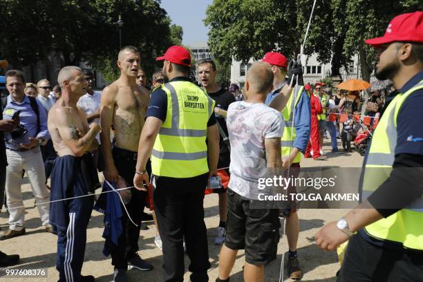 Supporters of US President Donald Trump confront activists flying a giant balloon depicting US President Donald Trump as an orange baby during a...