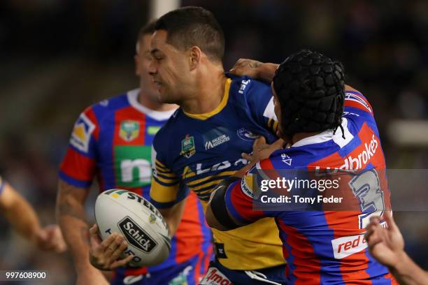 Jarryd Hayne of the Eels is tackled during the round 18 NRL match between the Newcastle Knights and the Parramatta Eels at McDonald Jones Stadium on...