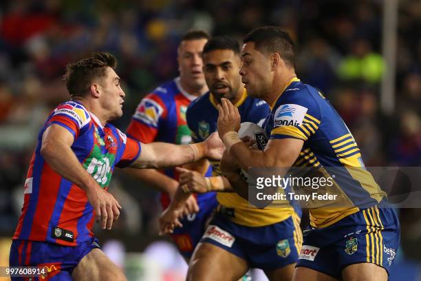 Jarryd Hayne of the Eels is tackled during the round 18 NRL match between the Newcastle Knights and the Parramatta Eels at McDonald Jones Stadium on...