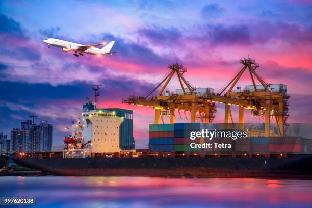 container cargo freight ship with working crane bridge in shipya - tetra images stock pictures, royalty-free photos & images