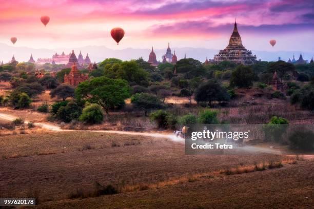 hot air balloon over plain of bagan in misty morni - tetra images stock pictures, royalty-free photos & images