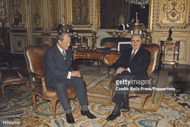 Chancellor of West Germany Willy Brandt pictured sitting together on left with French President Georges Pompidou in Pompidou's study at the Elysee...