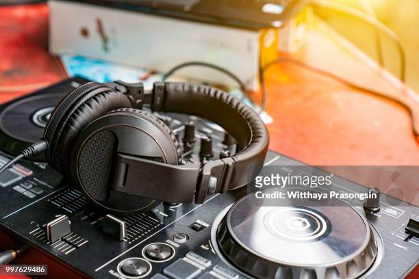 dj spinning, mixing, and scratching in a night club - dj table stock pictures, royalty-free photos & images