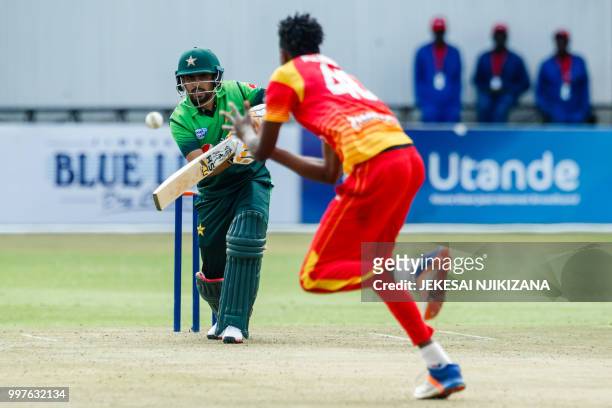 Pakistan batsman Babar Azam watches the ball after playing a shot during the first one day international cricket match between Pakistan and Zimbabwe...