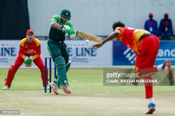 Pakistan batsman Imam-Ul-Haq is watched by Zimbabwe's wicketkeeper Peter Moor as he plays a shot during the first one day international cricket match...