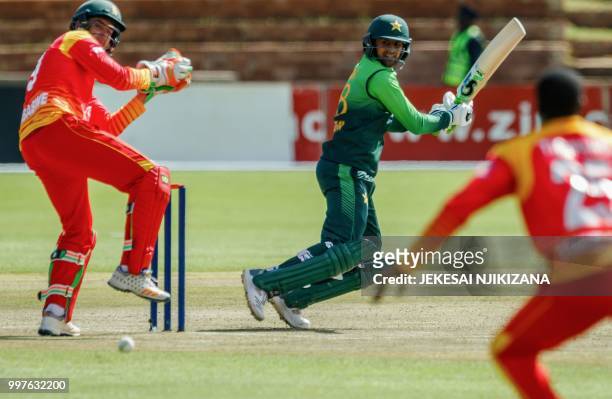 Pakistan's batsman Shoaib Malik plays a shot past Zimbabwe's wicketkeeper Peter Moor during the first one day international cricket match between...