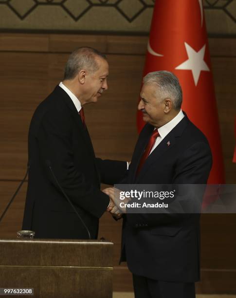 Turkish President Recep Tayyip Erdogan gives the medal to honor Turkish Grand National Assembly Speaker Binali Yildirim with Order of Merit for his...