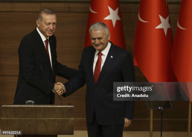 Turkish President Recep Tayyip Erdogan gives the medal to honor Turkish Grand National Assembly Speaker Binali Yildirim with Order of Merit for his...