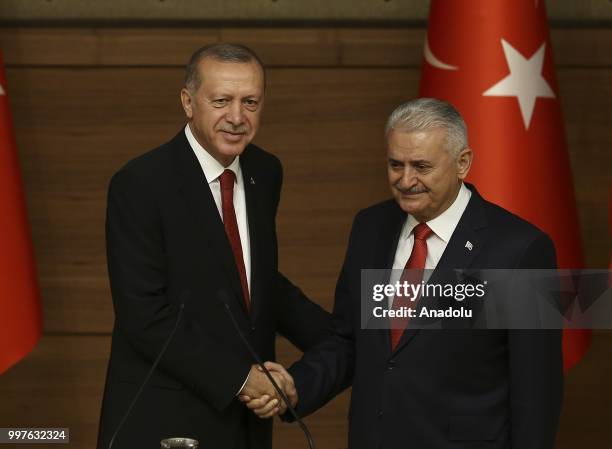 Turkish President Recep Tayyip Erdogan gives the medal to honor Turkish Grand National Assembly Speaker Binali Yildirim with Order of Merit for his...