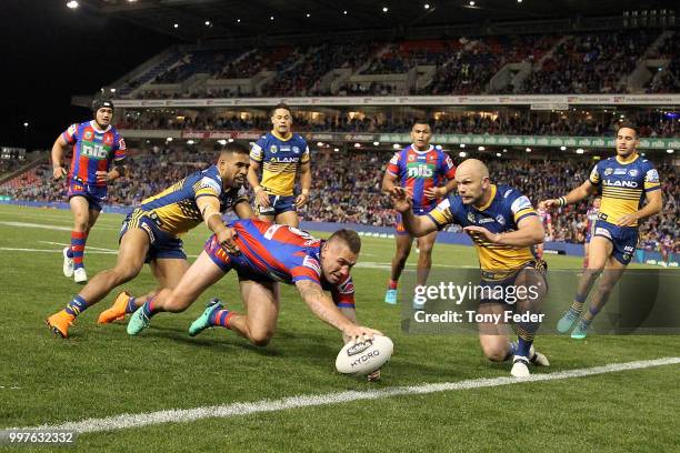 Shaun Kenny-Dowall of the Knights scores a try during the round 18 NRL match between the Newcastle Knights and the Parramatta Eels at McDonald Jones...