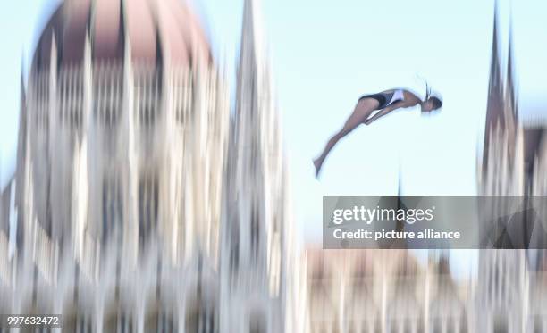 The US-American high diver Tara Tira jumps off 20 metres hight in front of the scene of the Hungarian parliament during the women's 20m high diving...