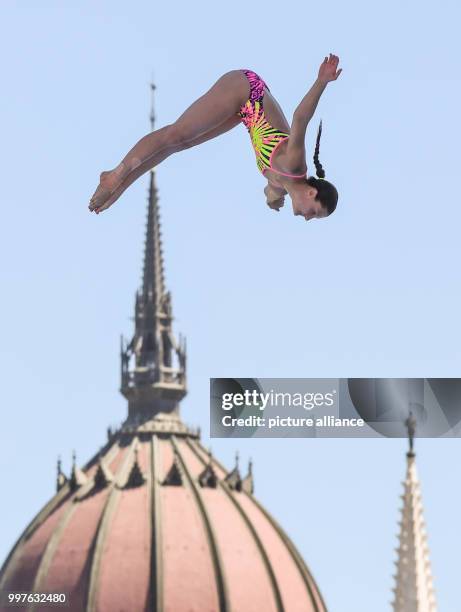 The German high diver Iris Schmidbauer jumps off 20 metres hight in front of the scene of the Hungarian parliament during the women's 20m high diving...