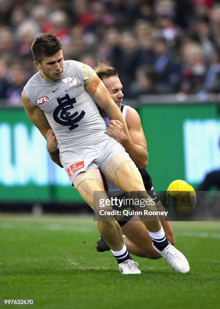 Marc Murphy of the Blues is tackled by Bailey Rice of the Saints during the round 17 AFL match between the St Kilda Saints and the Carlton Blues at...
