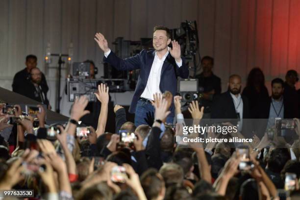 Tesla-CEO Elon Musk is celebrated by employees during the presentation of the first more reasonable Tesla vehicle Model 3 on the company grounds in...