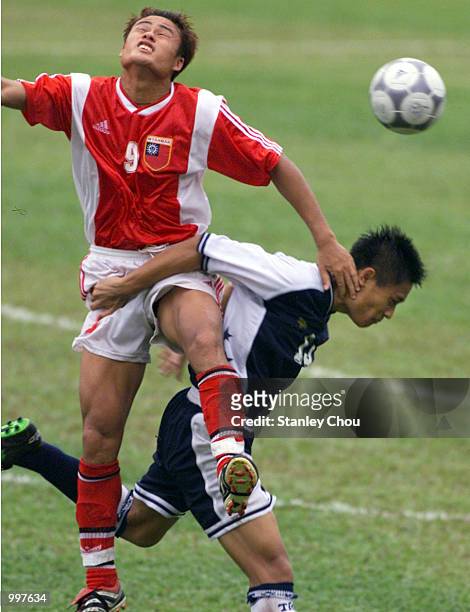 Nay Thu Hlaing of Myanmar in an aerial duo with Razaleigh Khalik of Singapore in a Group A match at the MPPJ Stadium, Petaling Jaya, Malaysia during...