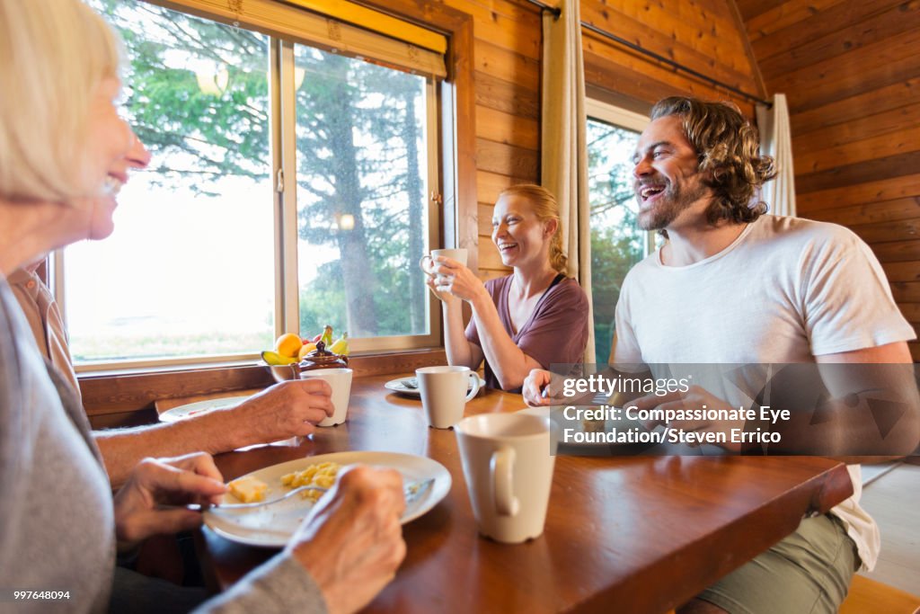 Family enjoying breakfast in cabin