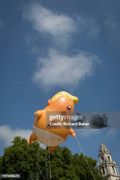 The inflatable balloon called Baby Trump flies above Parliament Square in Westminster, the seat of the UK Parliament, during the US President's visit...