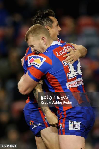 Mitchell Pearce of the Knights celebrates his try with Mitch Barnett during the round 18 NRL match between the Newcastle Knights and the Parramatta...