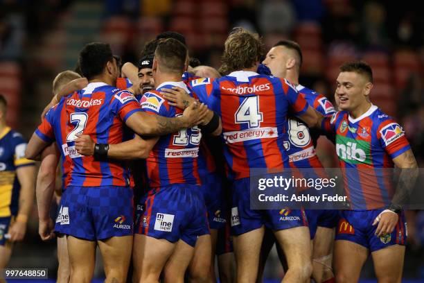 Mitchell Pearce of the Knights celebrates his try with team mates during the round 18 NRL match between the Newcastle Knights and the Parramatta Eels...