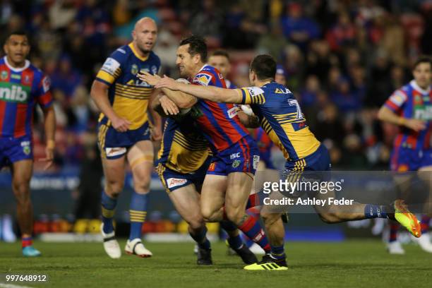 Mitchell Pearce of the Knights runs in to score a try during the round 18 NRL match between the Newcastle Knights and the Parramatta Eels at McDonald...