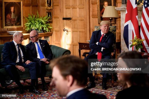 President Donald Trump speaks to Britain's Prime Minister Theresa May as White House Chief of Staff John Kelly and US Ambassador to the United...