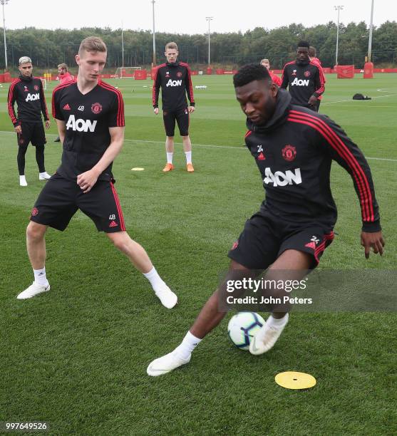 Ethan Hamilton and Timothy Fosu-Mensah of Manchester United in action during a first team training session at Aon Training Complex on July 13, 2018...