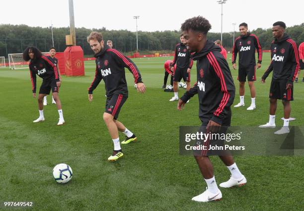 Tahith Chong, Daley Blind and Angel Gomes of Manchester United in action during a first team training session at Aon Training Complex on July 13,...