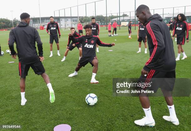 Anthony Martial, Angel Gomes and Eric Bailly of Manchester United in action during a first team training session at Aon Training Complex on July 13,...
