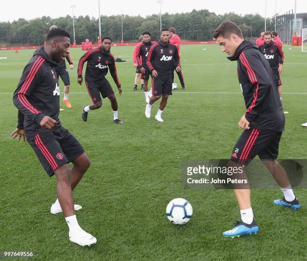 Timothy Fosu-Mensah and Ander Herrera of Manchester United in action during a first team training session at Aon Training Complex on July 13, 2018 in...