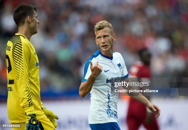 Hertha's goalkeeper Rune Jarstein chats with teammate Fabian Lustenberger during the international club friendly soccer match between Hertha BSC and...