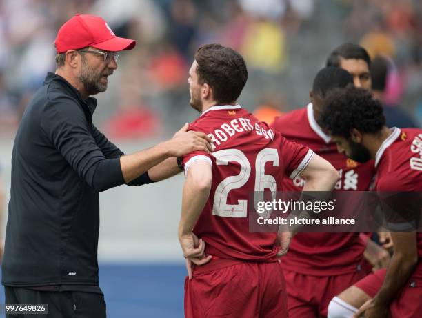 Liverpool's manager Juergen Klopp talks to Andrew Robertson at half-time during the international club friendly soccer match between Hertha BSC and...