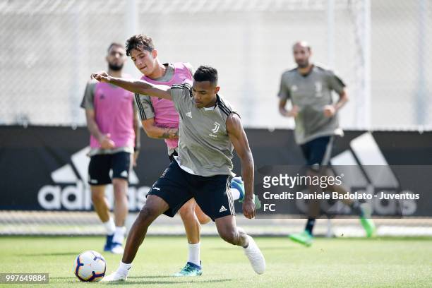Alessandro Di Pardo and Alex Sandro during a Juventus training session at Juventus Training Center on July 13, 2018 in Turin, Italy.