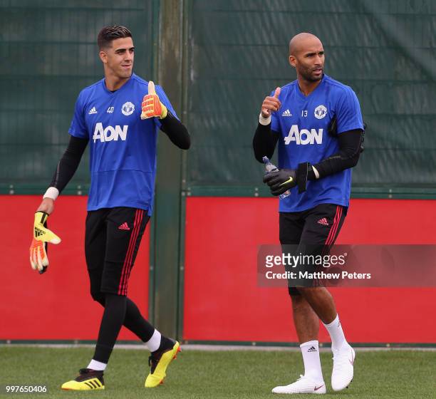 Joel Pereira and Lee Grant of Manchester United in action during a first team training session at Aon Training Complex on July 13, 2018 in...
