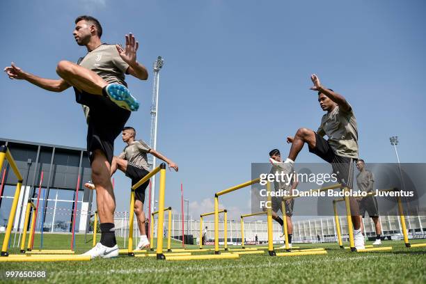 Andrea Barzagli and Alex Sandro during a Juventus training session at Juventus Training Center on July 13, 2018 in Turin, Italy.