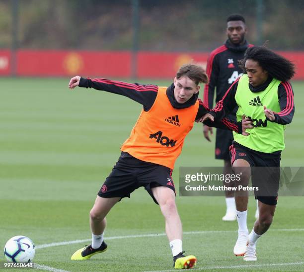 James Garner and Tahith Chong of Manchester United in action during a first team training session at Aon Training Complex on July 13, 2018 in...