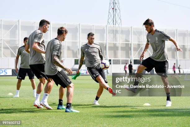 Federico Bernardeschi and Daniele Rugani during a Juventus training session at Juventus Training Center on July 13, 2018 in Turin, Italy.