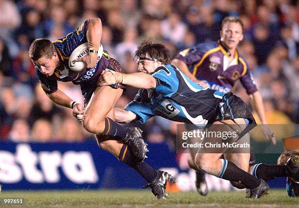 Ashley Harrison of the Broncos is tackled by Martin Lang of the Sharks during the NRL First Qualifying Final between the Cronulla Sharks and the...