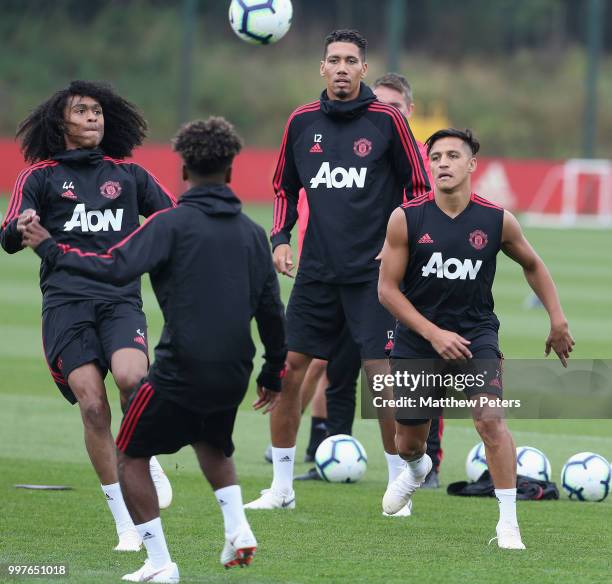 Tahith Chong, Chris Smalling and Alexis Sanchez of Manchester United in action during a first team training session at Aon Training Complex on July...