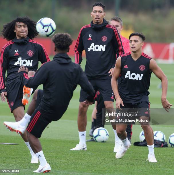 Tahith Chong, Chris Smalling and Alexis Sanchez of Manchester United in action during a first team training session at Aon Training Complex on July...