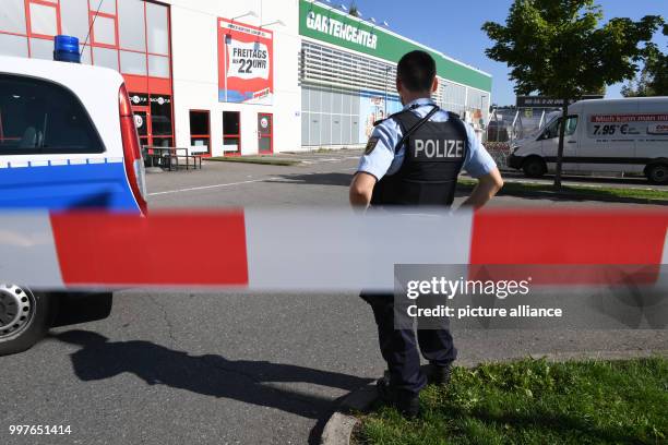 Policeman stands behind a barrier tape in front of the Club Grey in Konstanz, Germany, 30 July 2017. One person died from the shots fired at the...