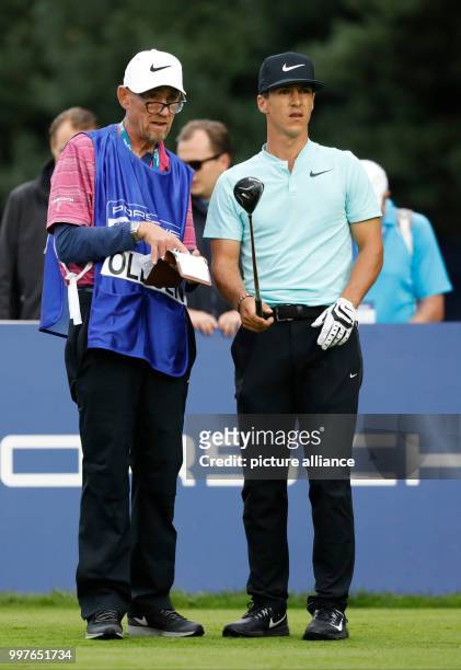 Thorbjorn Olesen from Denmark talks to his caddie during the 4th round of the Men's Singles at the European PGA Championship golf tournament in...