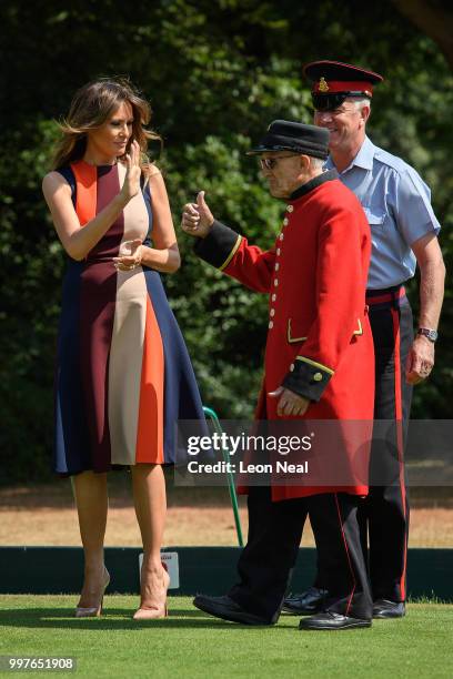 First Lady, Melania Trump, high-fives a Chelsea Pensioners as she tries her hand at bowls as she meets British Army veteransat Royal Hospital Chelsea...