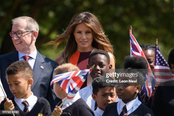 First Lady, Melania Trump, stands with school children after trying her hand at bowls as she meets British Army veteransat Royal Hospital Chelsea on...