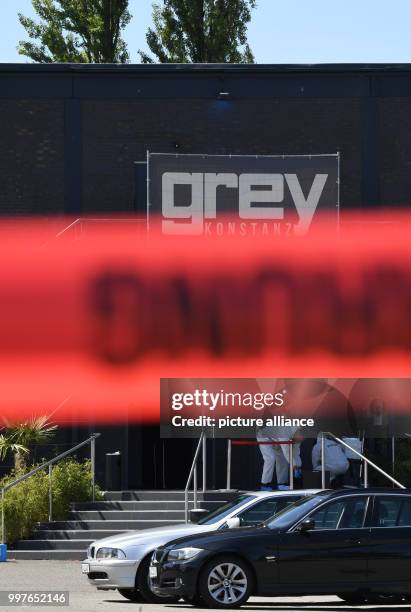 Police officers of the crime scene unit work in front of the Club Grey behind police barrier tape in Konstanz, Germany, 30 July 2017. One person died...